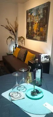 a table with two glasses and a bottle of wine at El Rosedal in Lima
