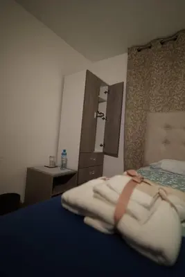 a bedroom with a bed with a dresser and a mirror at El Rosedal in Lima