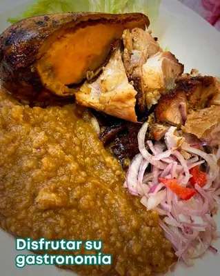 a white plate of food with meat and vegetables at PANDA Hotel in Chancay