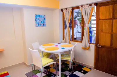 a small dining room with a white table and chairs at Historical Center Apartments in Cusco