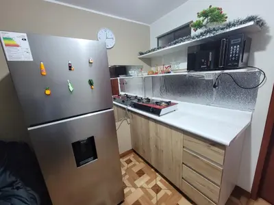 a kitchen with a stainless steel refrigerator and a counter at LUJO HOGAR - Cerca a Plaza Norte - UNI - Aeropuerto in Lima
