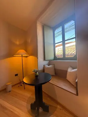 a small room with a table and a window at Hotel 1821 in Cusco