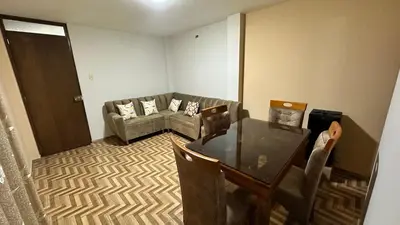 a living room with a couch and a table at Habitación privada a 20 min del Aeropuerto de LIMA in Lima