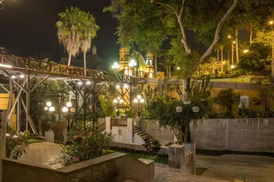 a park at night with lights and a building at Departamento en Barranco in Lima