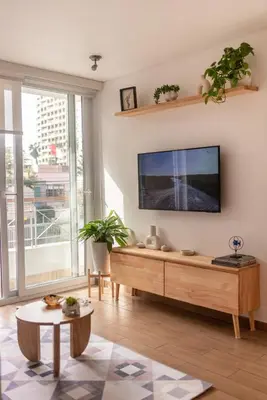 a living room with a flat screen tv on a wall at Departamento en Barranco in Lima