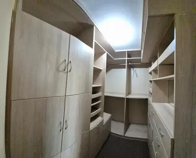 a room with a large wooden closet with shelves at Dormitorio con baño privado a 25 minutos del Apto in Lima