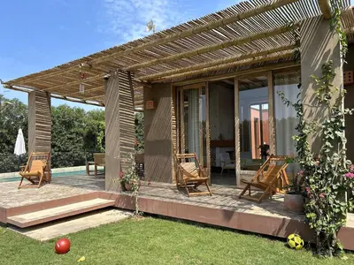 a house with a pergola and chairs on a patio at Casa de Campo con Piscina, BBQ y Naturaleza Cañete in Imperial