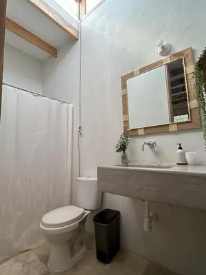 a bathroom with a toilet and a sink and a mirror at Casa de Campo con Piscina, BBQ y Naturaleza Cañete in Imperial