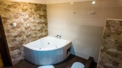 a bathroom with a bath tub and a sink at Casa en Calca in Calca