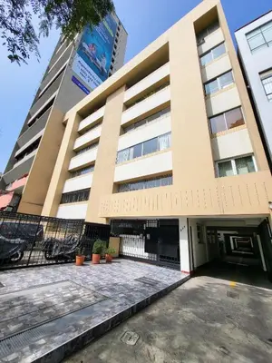 a building with a parking lot in front of it at Entire Apartment in Miraflores in Lima