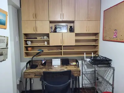 a room with a wooden desk with chairs and cabinets at Entire Apartment in Miraflores in Lima