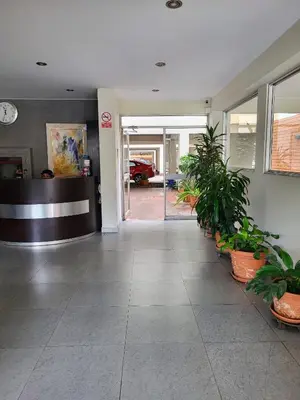an empty lobby with potted plants in a building at Entire Apartment in Miraflores in Lima