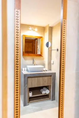 a bathroom with a sink and a mirror at Intiflatscusco Comfortable Stay in the Heart of the City in Cusco
