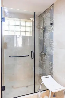 a shower with a glass door in a bathroom at Intiflatscusco Comfortable Stay in the Heart of the City in Cusco
