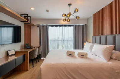 a bedroom with a bed with a desk and a television at Ejército City Lofts & Apartments in Lima