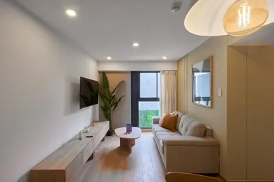 a living room with a couch and a table at Ejército City Lofts & Apartments in Lima