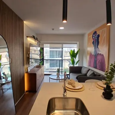 a kitchen and living room with a sink and a couch at Vive Barranco, Reserva aquí in Lima
