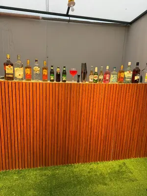 a wooden bar with a bunch of bottles of alcohol at Lima Hostel - Barranco in Lima