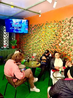 a group of people sitting at tables in a restaurant at Lima Hostel - Barranco in Lima