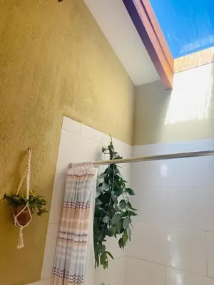 a bathroom with a plant in the shower at Charming Urubamba Cusco house - Kapuliyuq in Urubamba