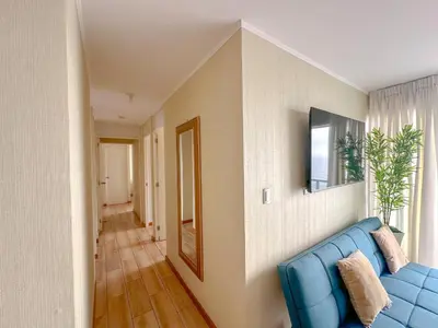 a living room with a blue couch and a window at Exclusivo con vista al mar - Blue Ocean in Lima
