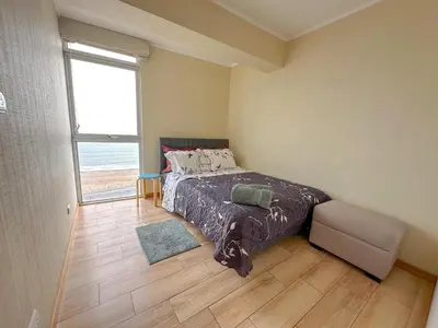 a bedroom with a bed and a large window at Exclusivo con vista al mar - Blue Ocean in Lima