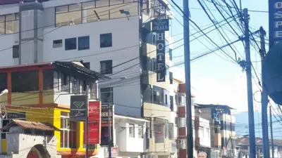 a group of buildings on a city street with power lines at Siball Hotel in Abancay