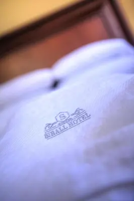 a white shirt with a logo on top of it at Siball Hotel in Abancay