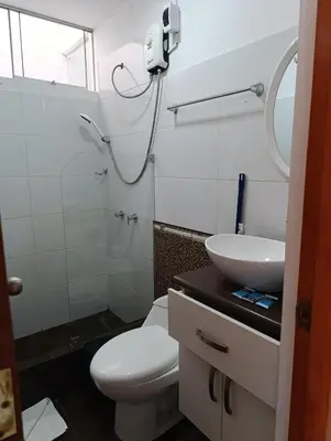 a bathroom with a toilet and a sink at Departamento Frente al Cc Mega plaza - Ica in Ica