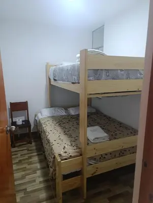 a bedroom with two bunk beds in a room at Departamento Frente al Cc Mega plaza - Ica in Ica