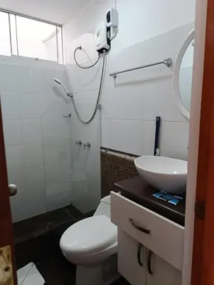 a bathroom with a white toilet and a sink at Departamento Frente al Cc Mega plaza - Ica in Ica