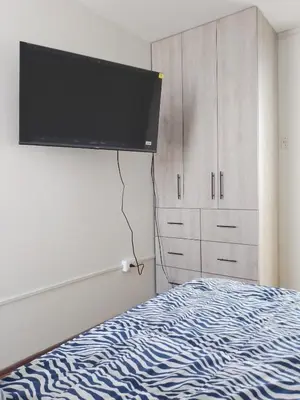 a bedroom with a bed and a flat screen tv at Miraflores, Lima, mini apartamento 2 ambientes in Lima