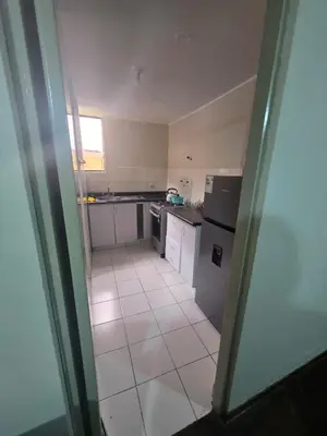 a kitchen with white appliances and a tile floor at RODRICH apartment 2 in Lima
