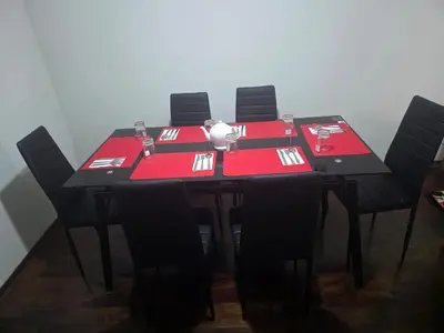 a table with black chairs and red napkins on it at RODRICH apartment 2 in Lima