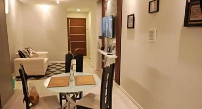 a dining room with a table and chairs in a living room at Posada del inka in Cusco