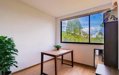a room with a table and a large window at La Panaca Del Inka Apartment in Cusco