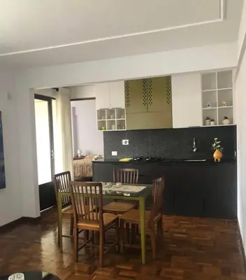 a kitchen with a dining room table and chairs at Inka Garden Apartment Cusco in Cusco
