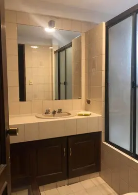 a bathroom with a sink and a large mirror at Inka Garden Apartment Cusco in Cusco