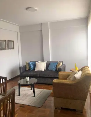 a living room with a couch and a table at Inka Garden Apartment Cusco in Cusco