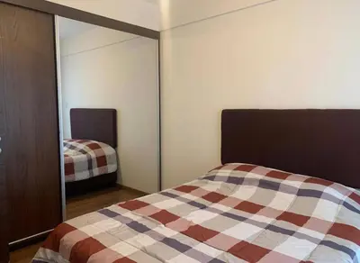 a bedroom with a bed and a mirror at Qori Apartment in Cusco