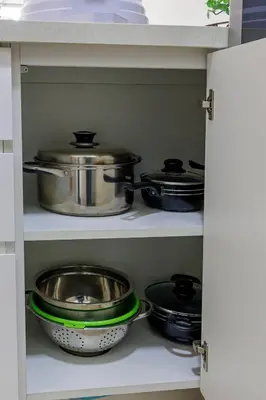 a shelf with pots and pans in a kitchen at BSR Romantic Escape Flat w/ Rooftop Pool in Lima