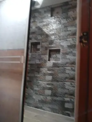 a view of a stone wall through a door at Si buscas un lugar para tu familia in Cusco
