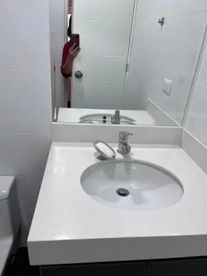 a person taking a picture of a bathroom sink at APARTMENT NEW COMFORTABLE in MIRAFLORES in Lima
