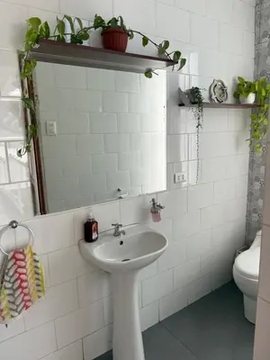 a white bathroom with a sink and a toilet at CasaHotel Chaclacayo in Chaclacayo