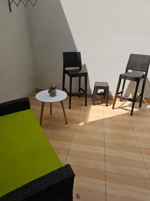 a room with chairs and a table and a couch at CasaHotel Chaclacayo in Chaclacayo