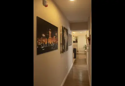 a hallway with pictures on the walls of a house at Apartamento familiar 3 habitaciones, piscina cerca a Miraflores in Lima