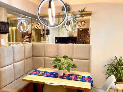 a table with a cushion on it in a restaurant at Apartamento familiar 3 habitaciones, piscina cerca a Miraflores in Lima
