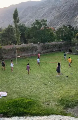 a group of children playing in a field at Viña J Felix in Lunahuaná