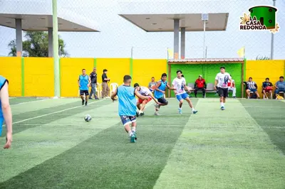 a group of people playing soccer on a field at La Casa Redonda - Supe in Barranca
