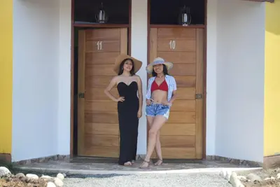 two women are standing in front of a door at La Casa Redonda - Supe in Barranca